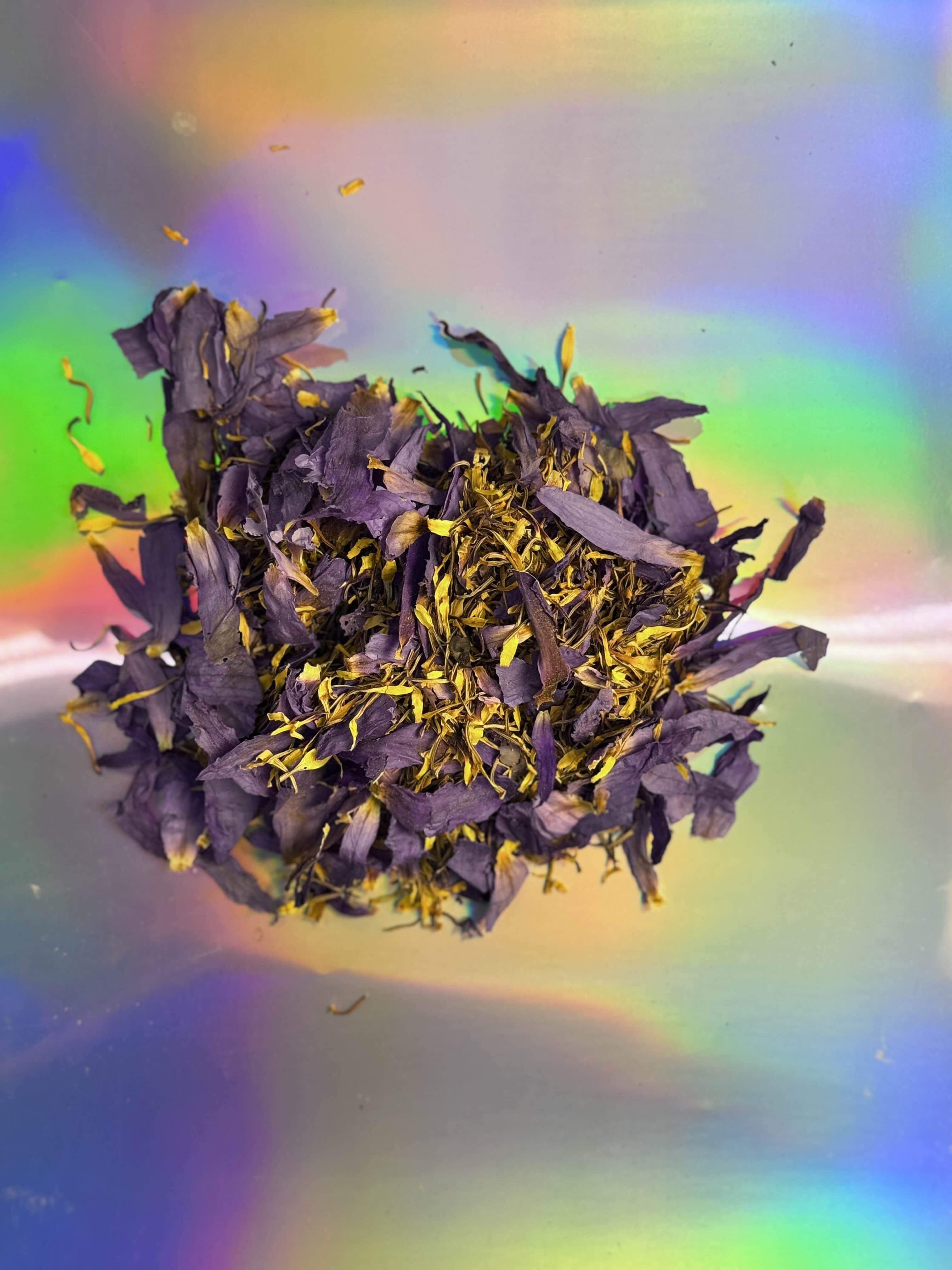 Blue Lotus Petals And Stamens Premium Dried Flower Blend For Tea By Healing Herbals. The flower petals are a blue and purple, with yellow stamens.