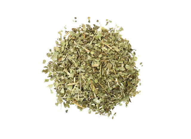 Top-down view of dried lemon verbena leaves by Healing Herbals, showing chopped green leaf pieces with thin stems on a clean white background.