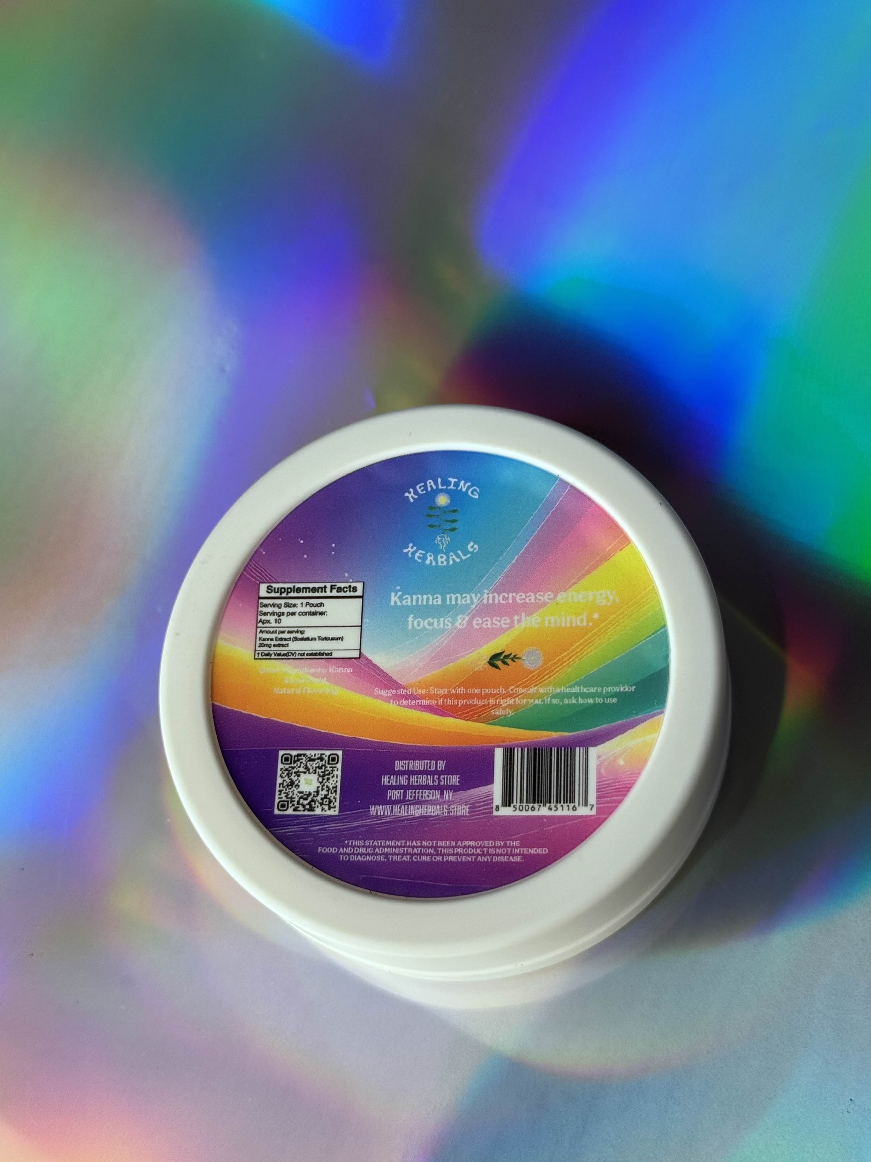 Bottom view of a white KYN Kanna Pouches container showing the Supplement Facts label, QR code, and barcode, displayed on a colorful iridescent background.