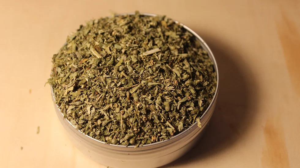 Organic loose-leaf catnip tea by Healing Herbals, showing dried green catnip leaves and stems in a clear round container on a warm wooden surface.