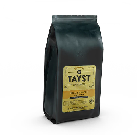 Black resealable coffee bag with yellow label reading “TAYST Coffee Roaster – Bold & Brazen,” featuring whole bean dark roast coffee, 12 oz.