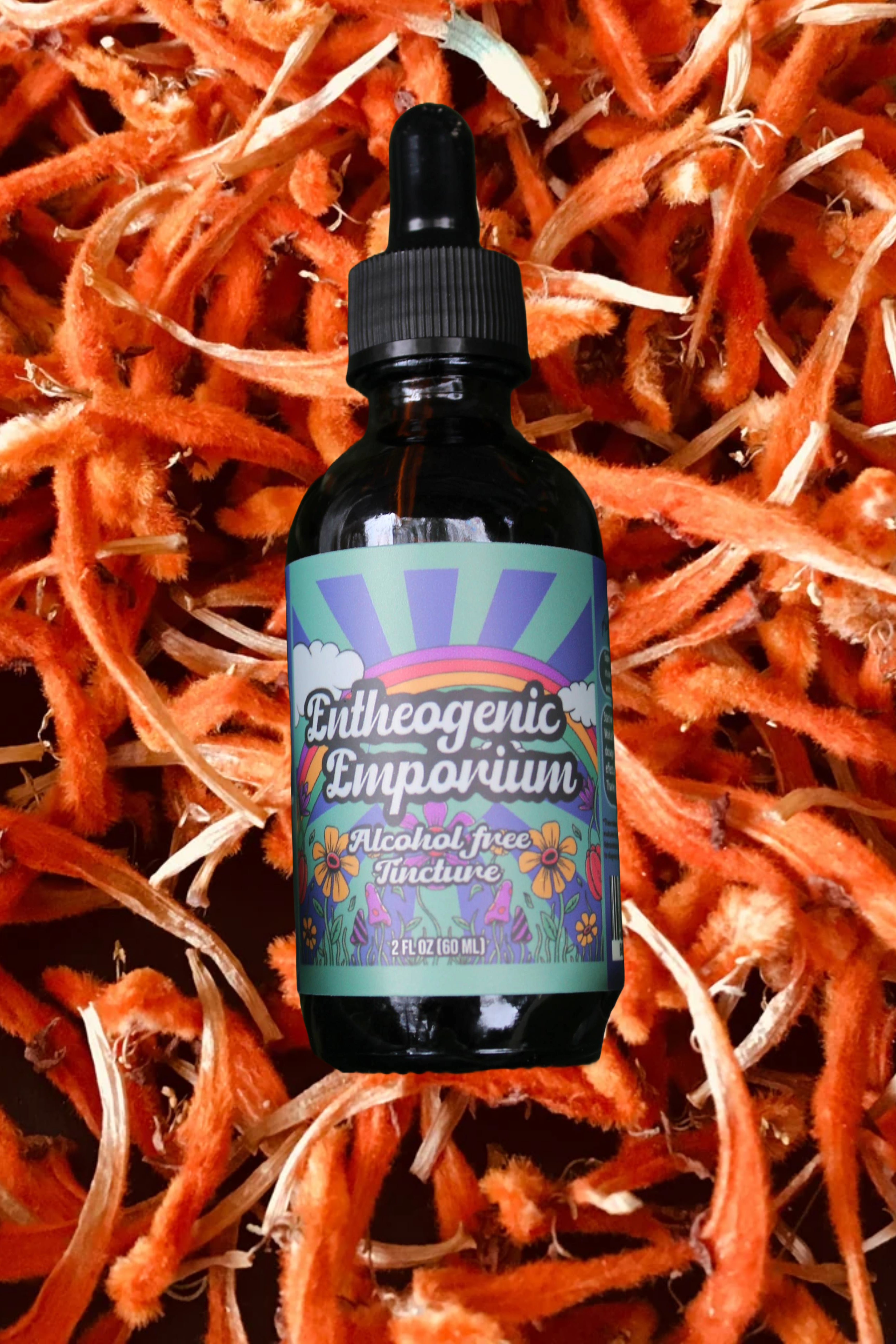 Dark glass dropper bottle labeled “Entheogenic Emporium Alcohol-Free Tincture,” displayed upright against a textured background of dried orange wild dagga petals and stems.