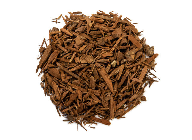 Dried yohimbe bark pieces with rich brown woody fragments, loose-cut herbal material displayed on a clean white background.