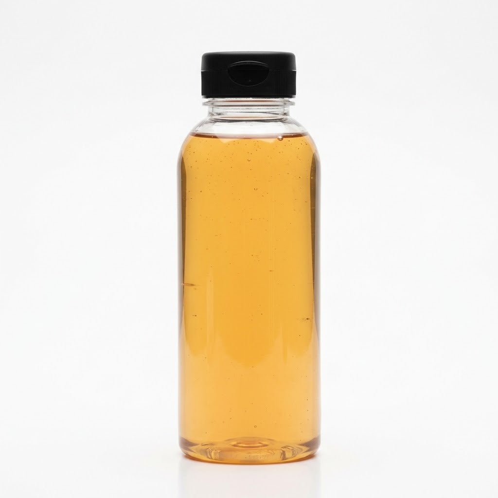 Clear 23 oz bottle of organic tapioca syrup with a black flip-top cap on a white background