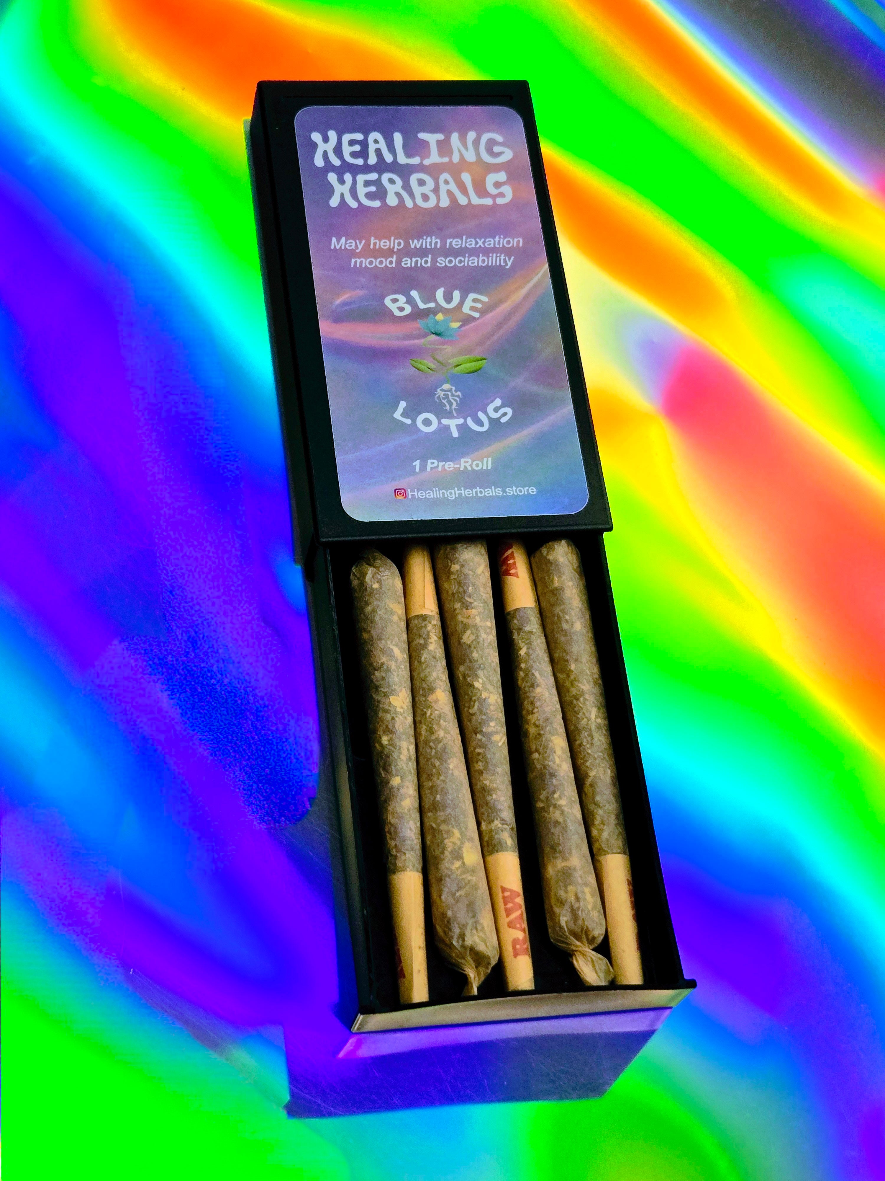 Healing Herbals Blue Lotus pre-roll pack with five herbal joints in black case on vibrant rainbow background