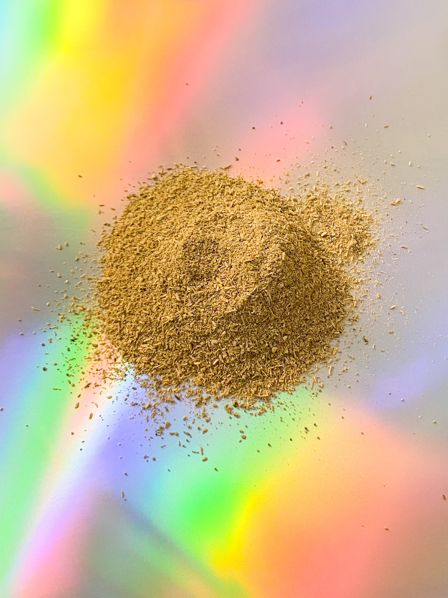 Medium-grind Fiji kava powder made from noble kava root, high-potency dried kava root product displayed on iridescent surface.