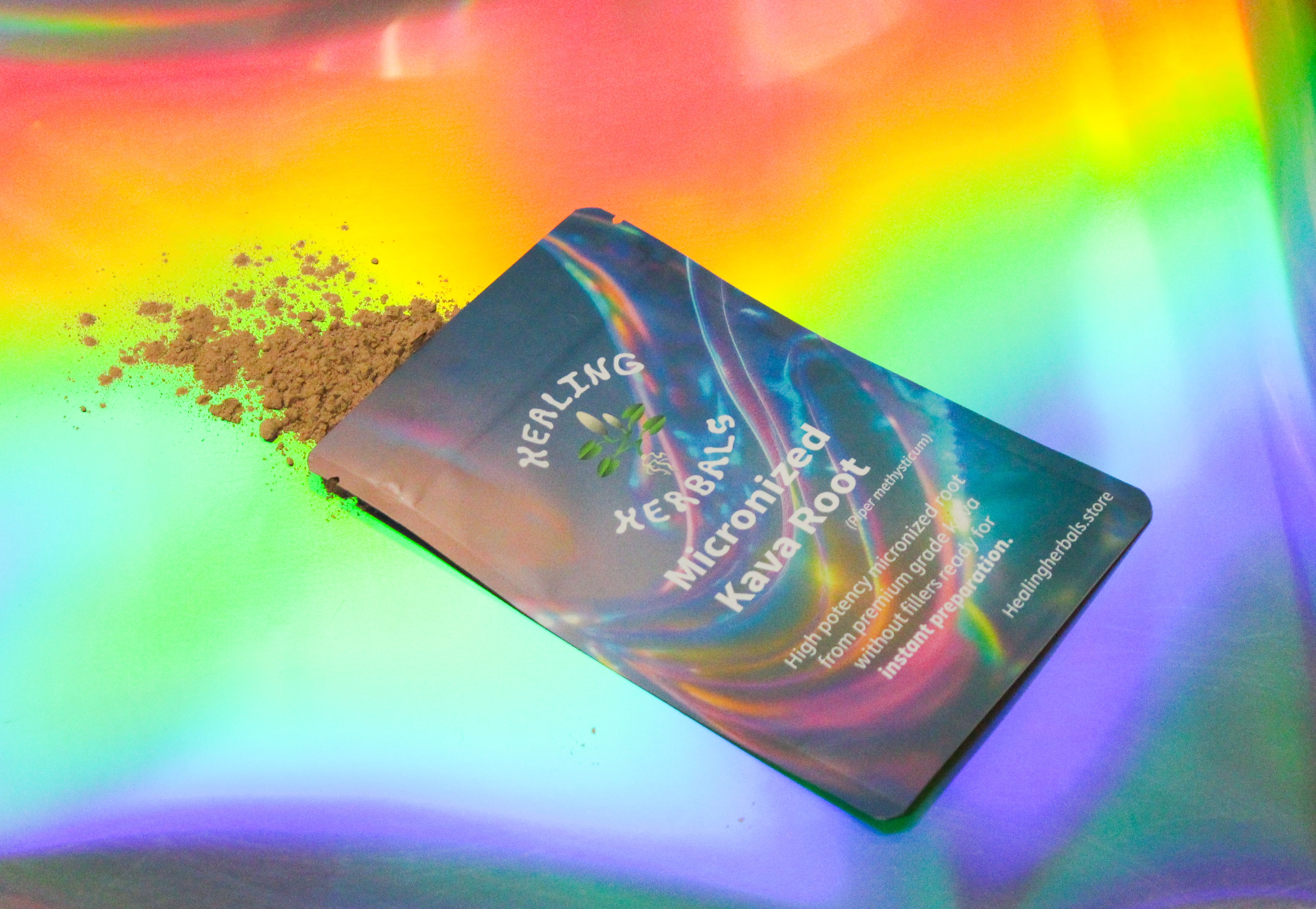 Healing Herbals micronized kava root powder pouch shown at an angle with loose kava powder spilling from the opening, photographed on a vibrant iridescent rainbow background highlighting the herbal packaging.
