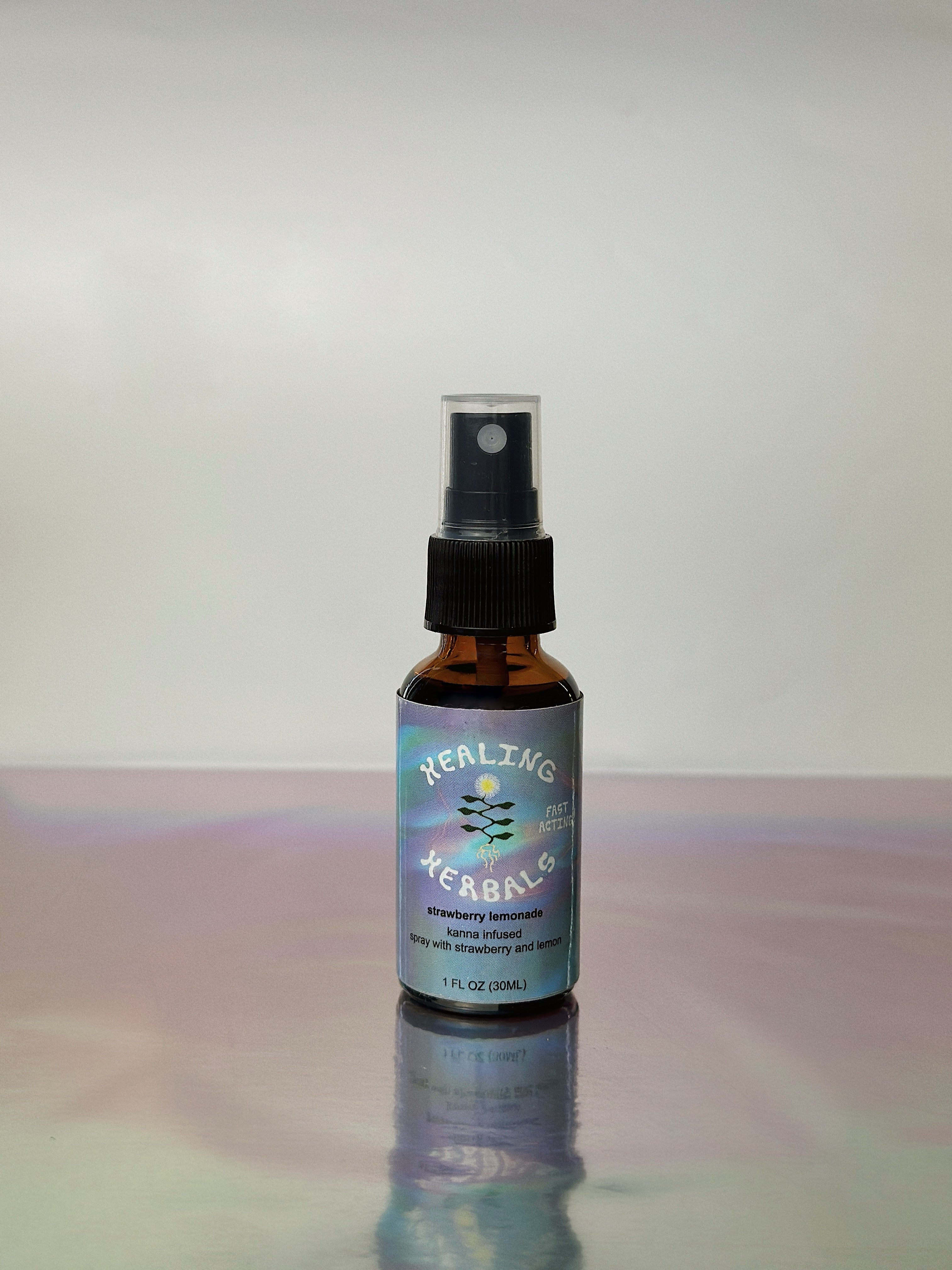 Healing Herbals strawberry lemonade kanna extract mouth spray in an amber glass bottle with black spray top, labeled fast-acting, displayed upright on a reflective surface against a clean neutral background.