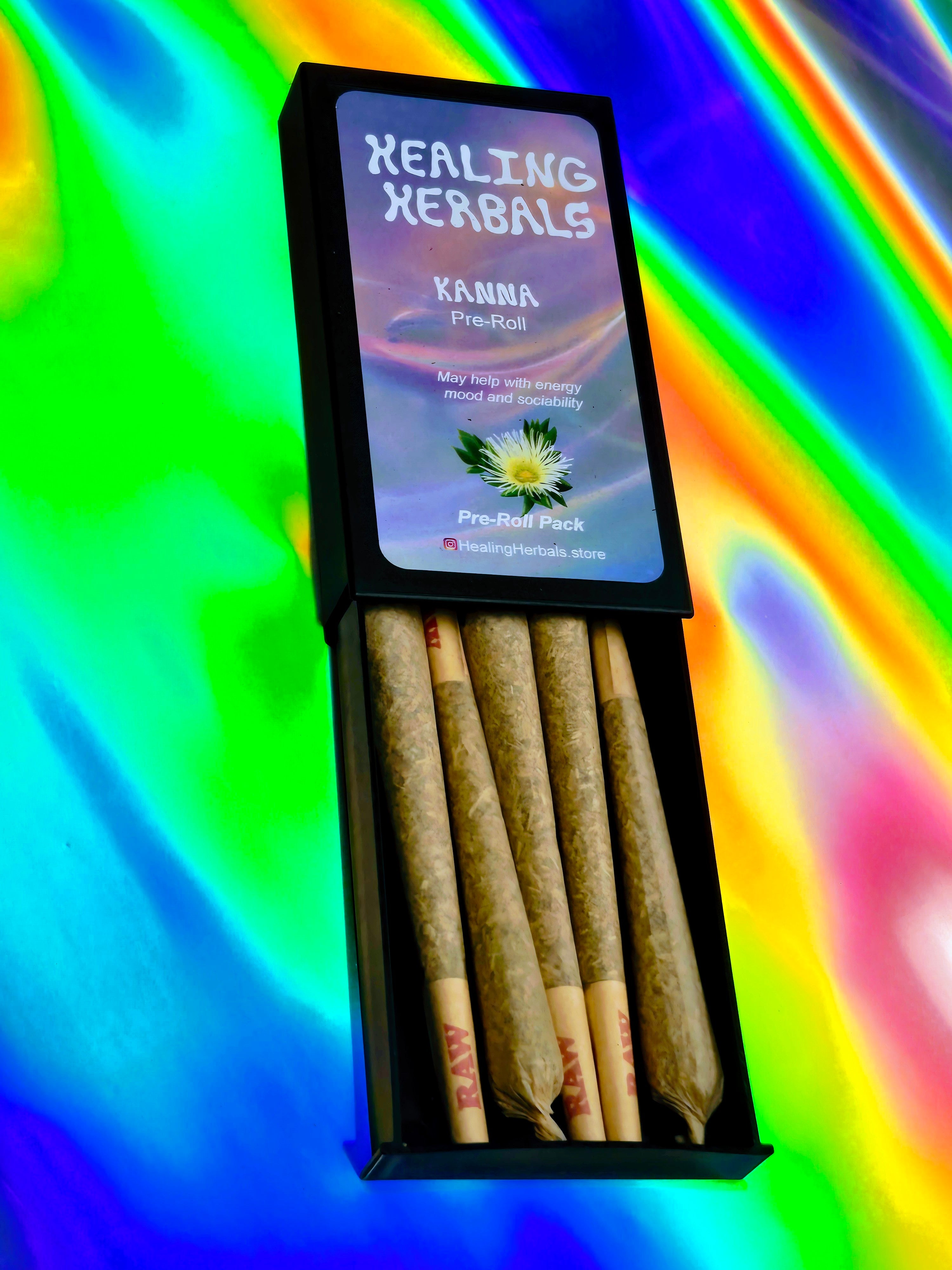 Healing Herbals Kanna pre-roll pack displayed open with five rolled herbal joints inside a black case, featuring branded packaging and photographed against a vibrant iridescent rainbow background.