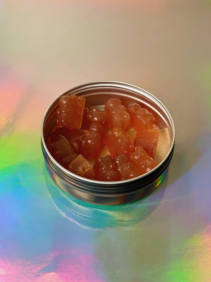 strawberry bear shaped Kanna gummies in a metal tin with rainbow backdrop. Sceletium Tortuosum Extract infused