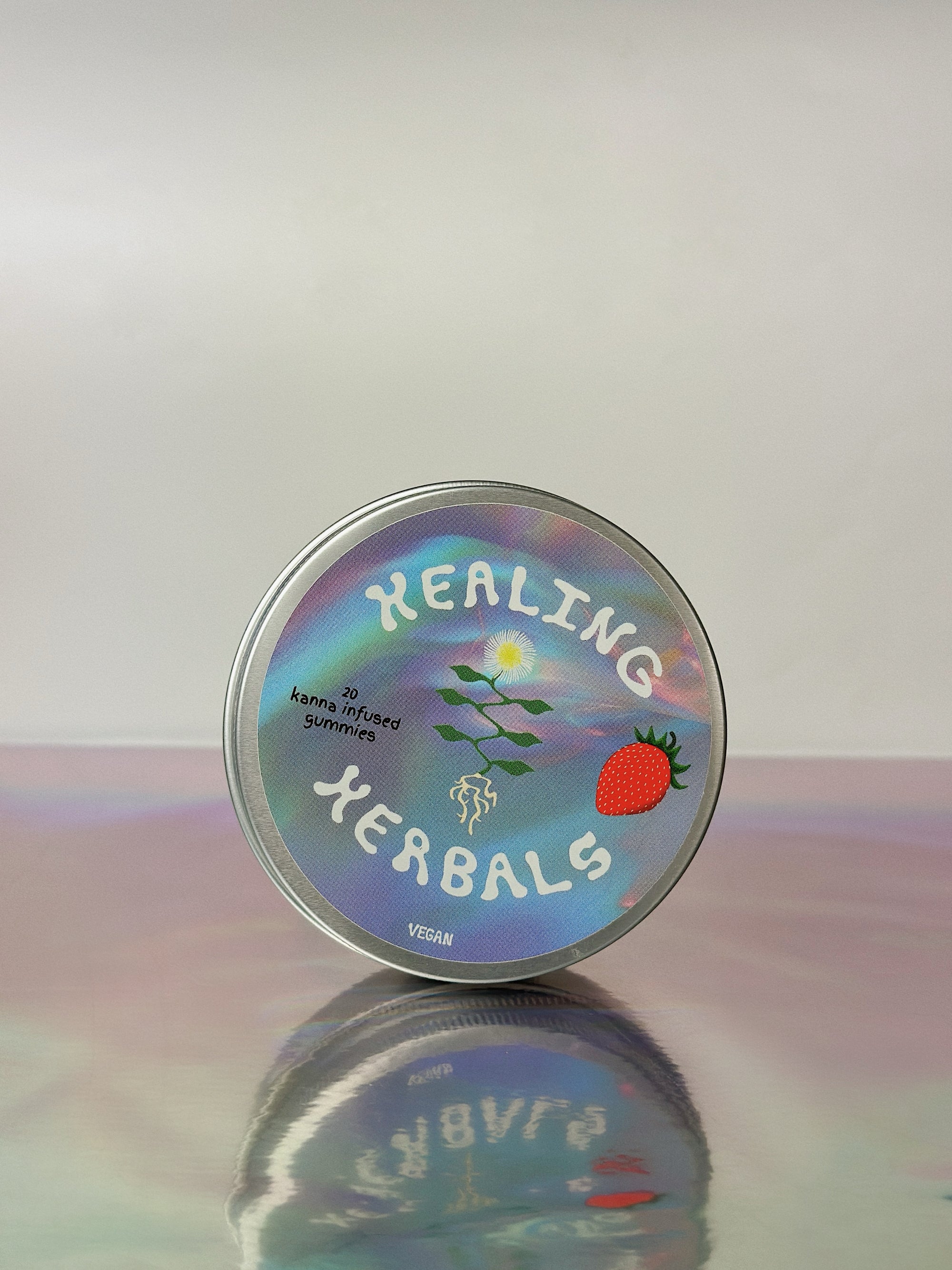 Our Strawberry Kanna Extract (Sceletium Tortuosum / Expansum) infused hummy tin over a grey / rainbow background. The center logo for our product is kanna with a big strawberry next to it in this case