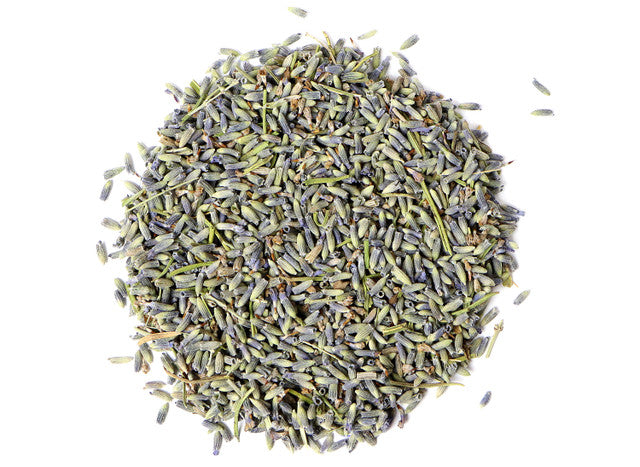 Top-down view of dried lavandin flowers by Healing Herbals, showing blue-purple buds and green stems with natural texture on a clean white background.