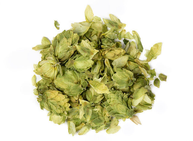 View of whole dried organic hops flowers with layered pale green cones, loose herbal botanicals arranged on a clean white background.